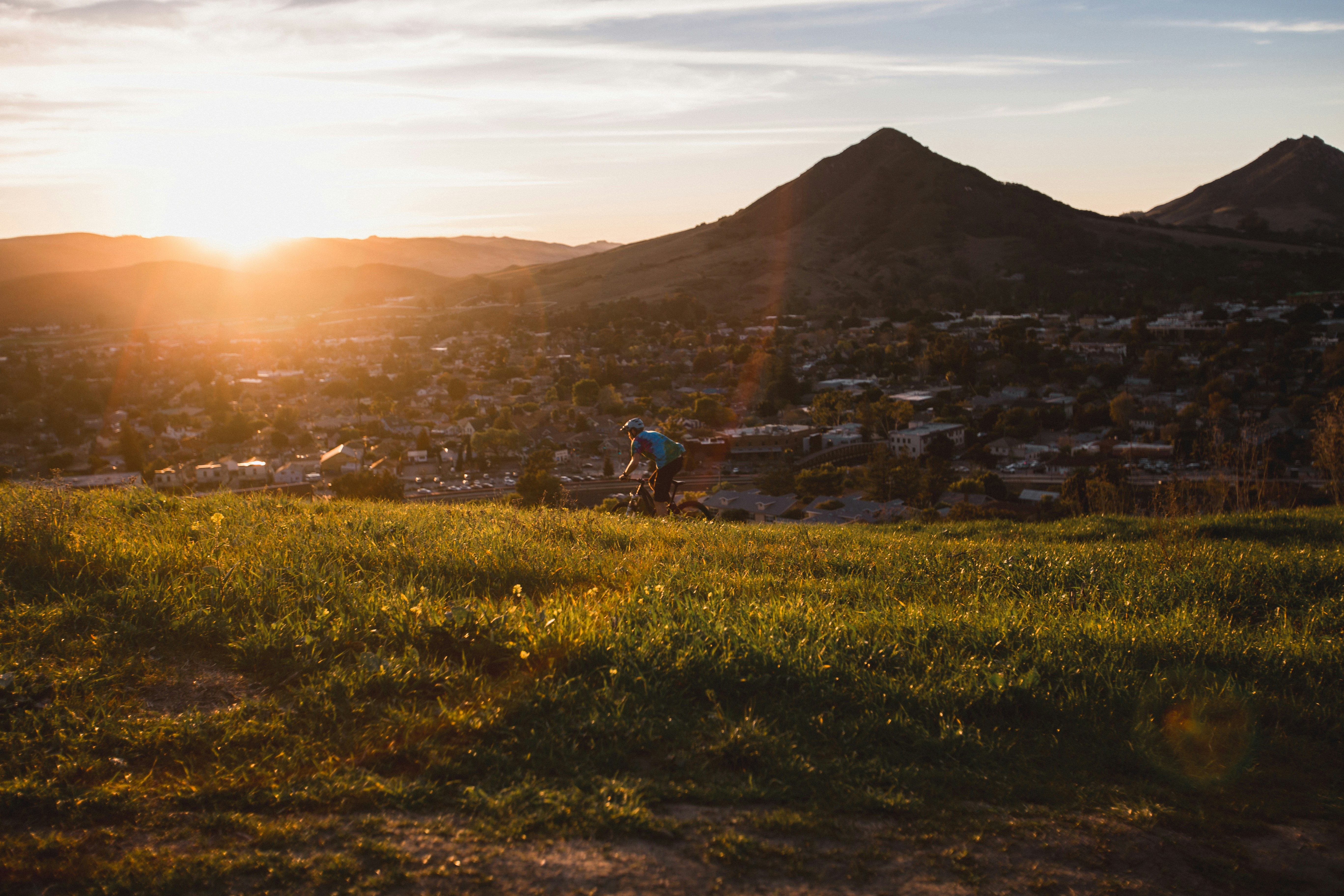 man riding bicycle during sunset.