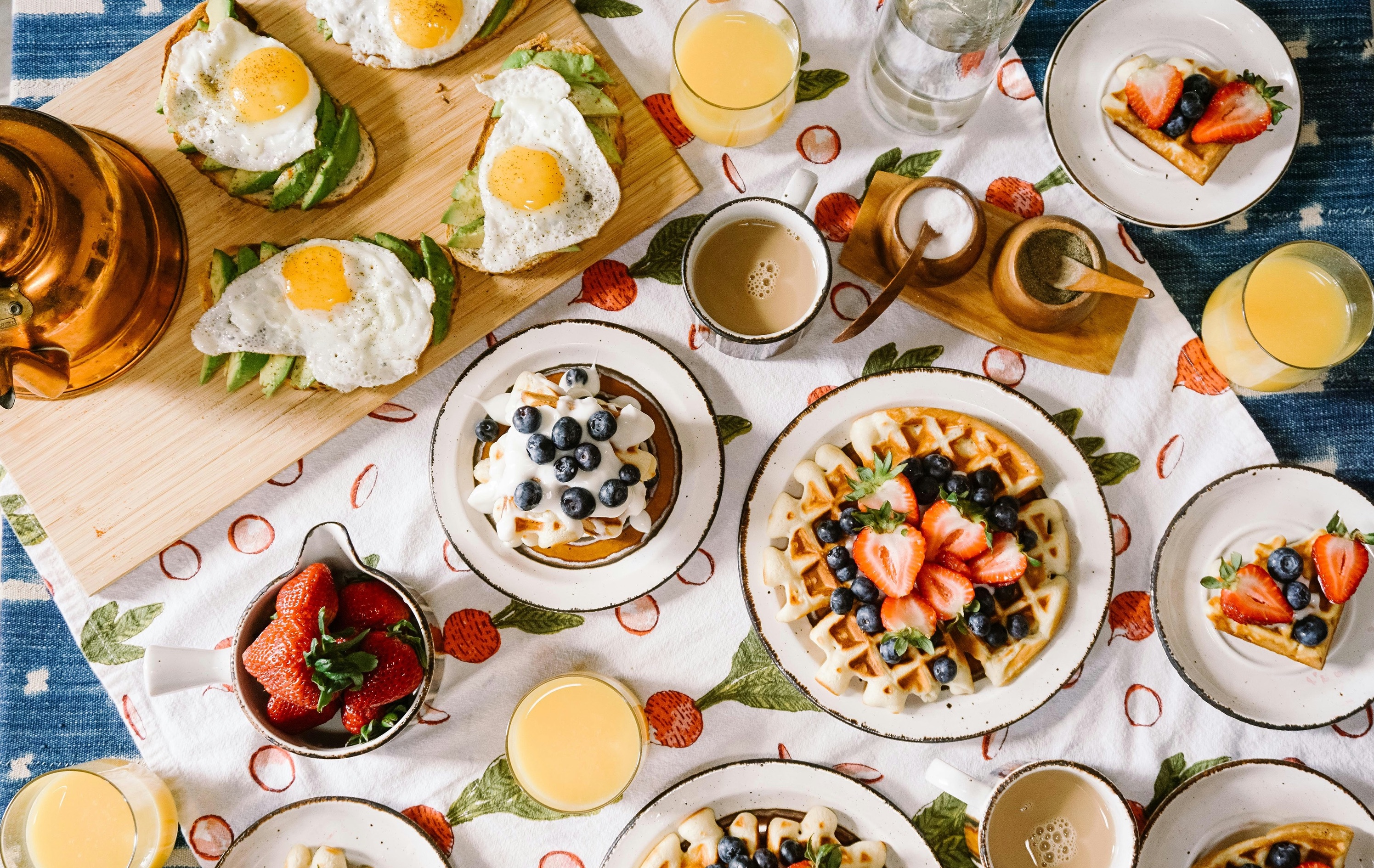 various breakfast dishes on a white tablecloth.