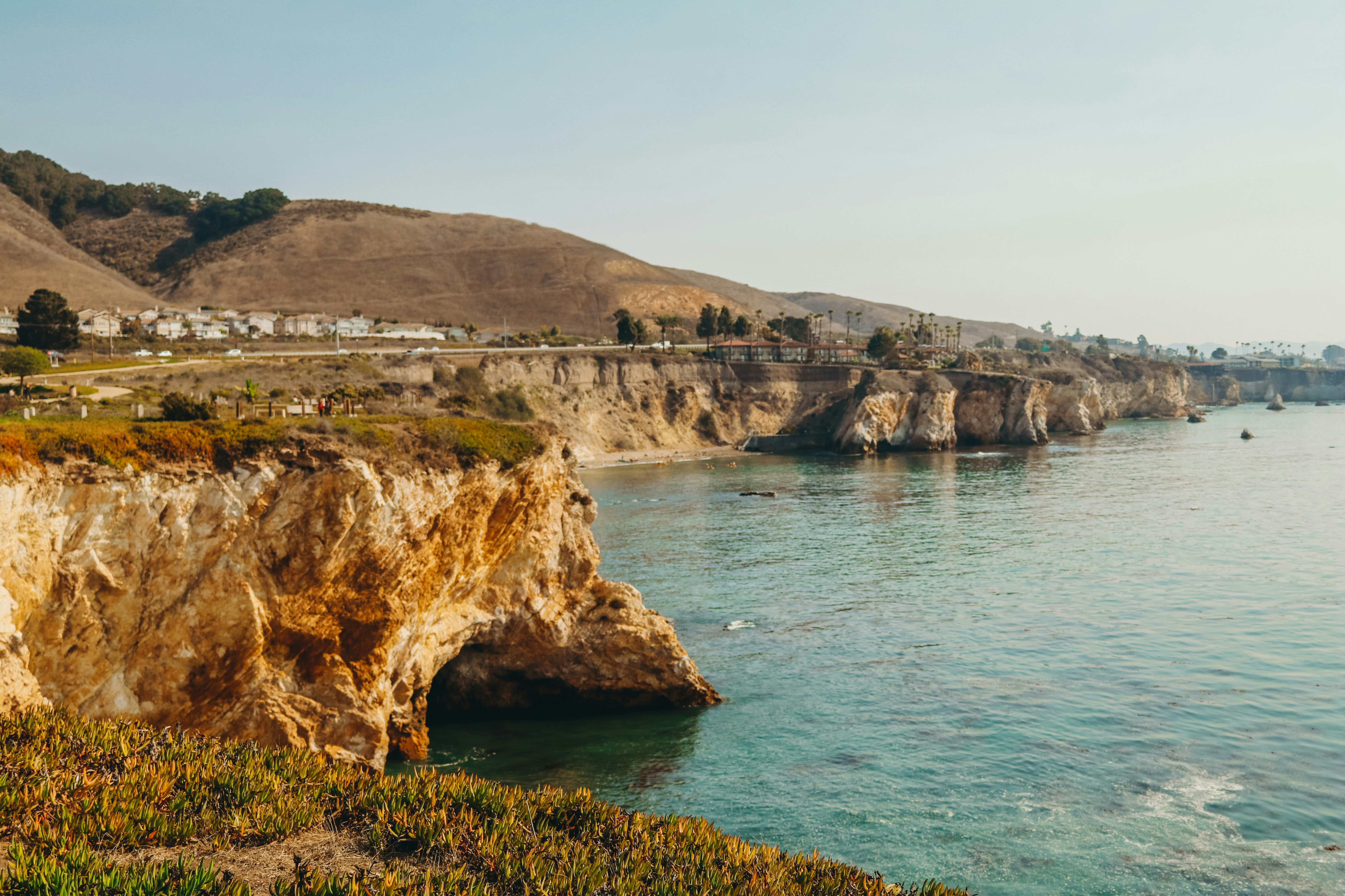 cliff near ocean during daytime.