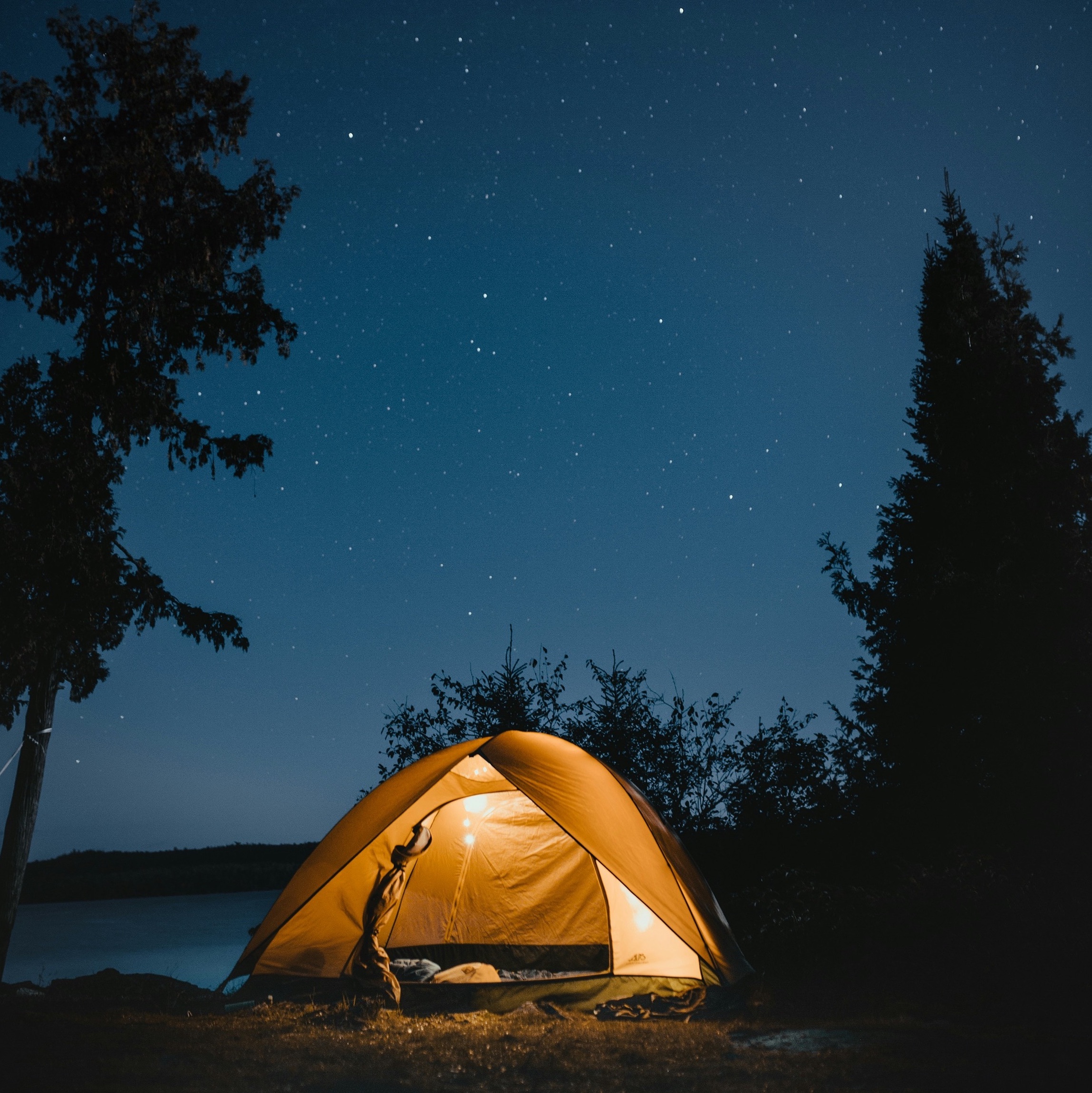 glowing yellow tent at night.